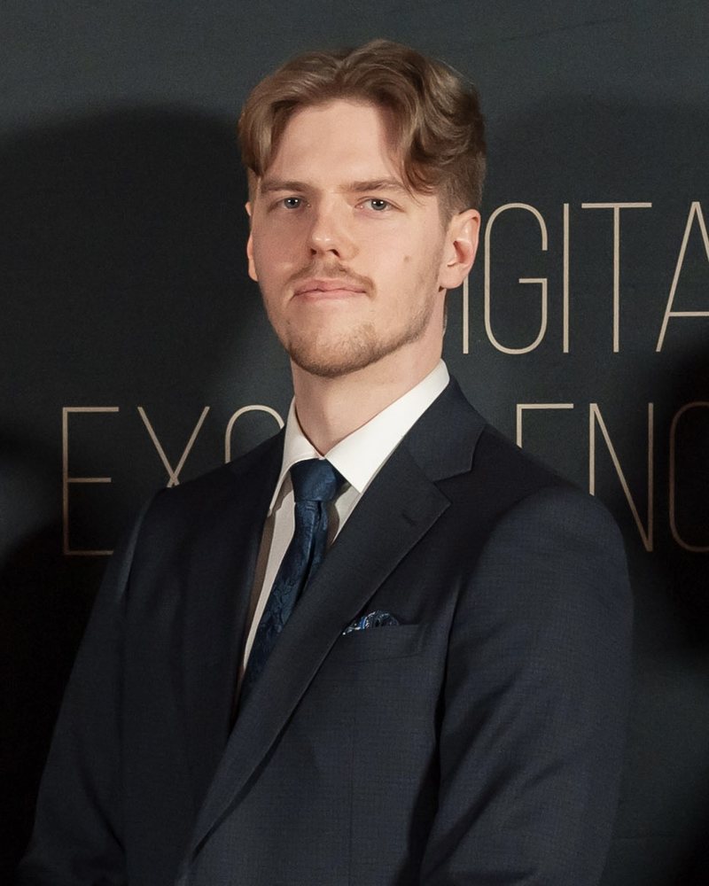 Portrait of Wiktor Oczkoś in a dark suit